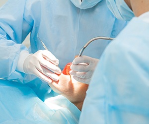 Surgically placing dental implants in Hammonton, NJ in patient’s mouth