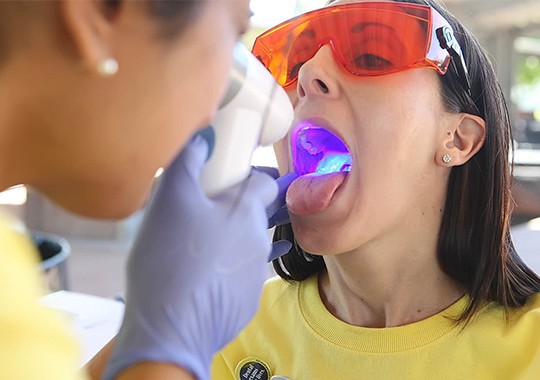 Woman receiving oral cancer screenings