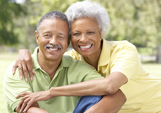 Smiling older man and woman outdoors