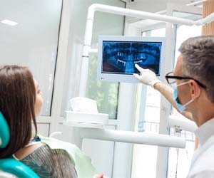 dentist showing a patient their X-rays