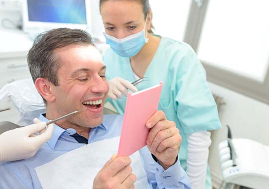 dental patient looking at his new smile