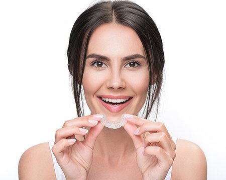 Woman placing Invisalign tray