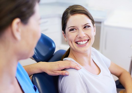 Woman in dental chair smiling