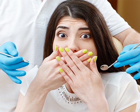 Woman covering her mouth