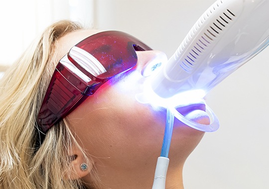 Woman receiving in-office teeth whitening