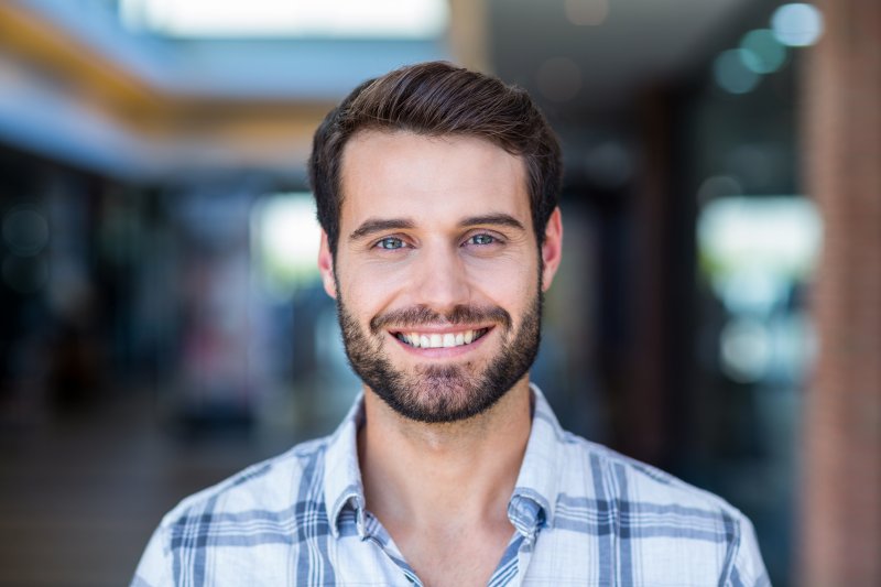 person with nice teeth thanks to dental implants smiling