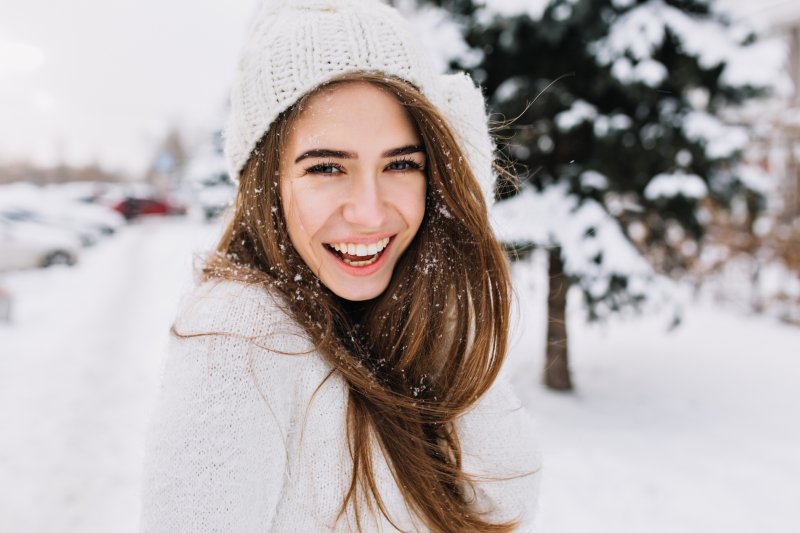 Young woman smiling in the snow
